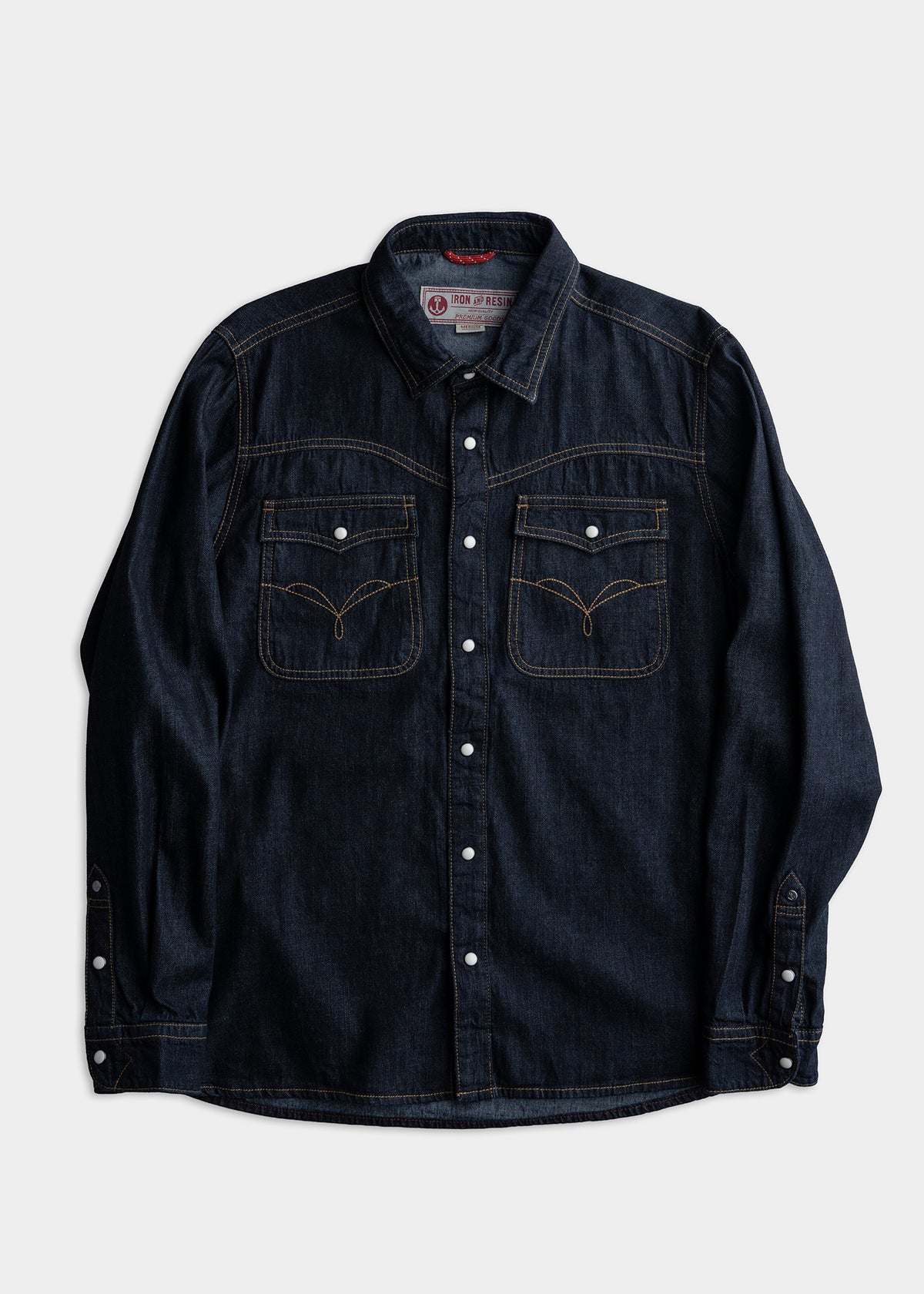 Dark denim shirt with white buttons, two chest pockets, and contrast stitching, laid flat on a white background.