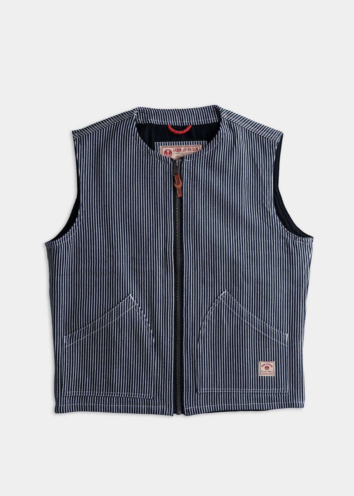 Blue and white striped vest with front zipper and pockets, featuring an Iron & Resin label, displayed on a plain background.