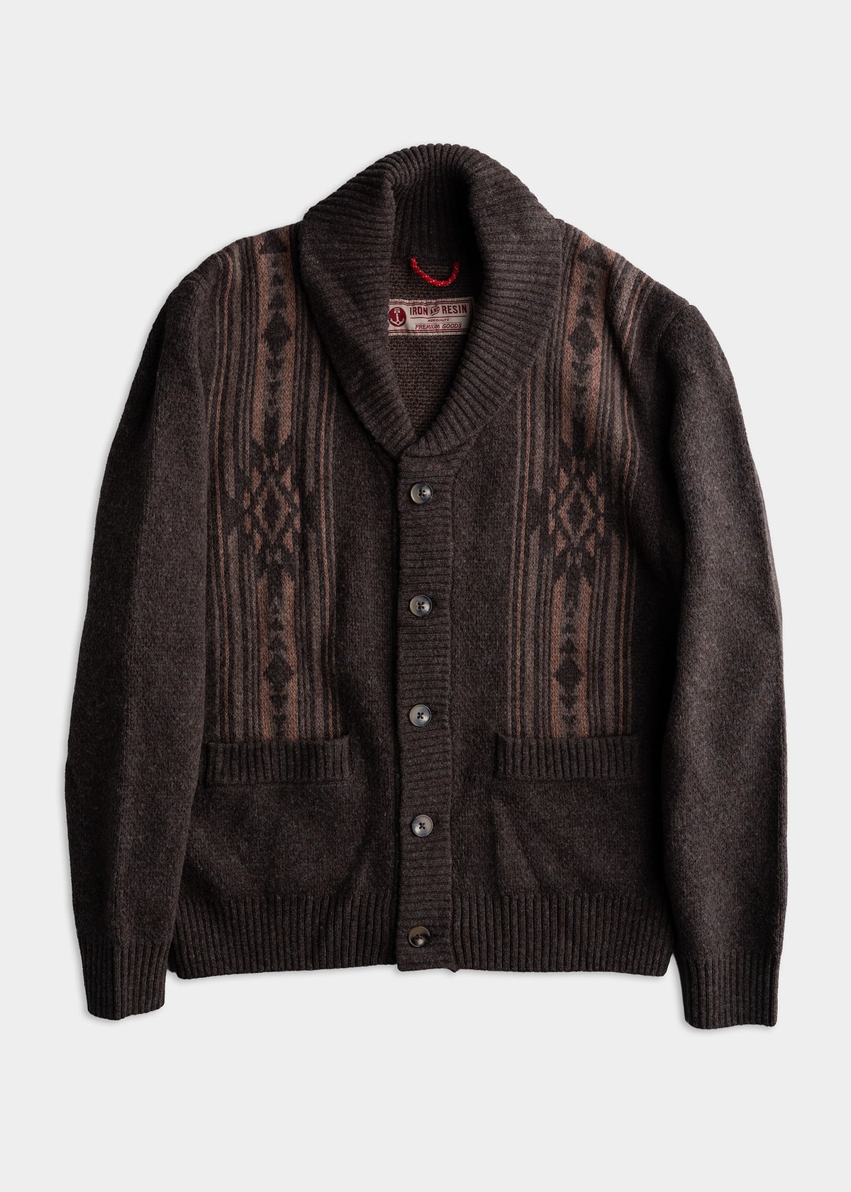 Brown shawl collar cardigan with geometric patterns, button front, and two pockets, laid flat on a white background.