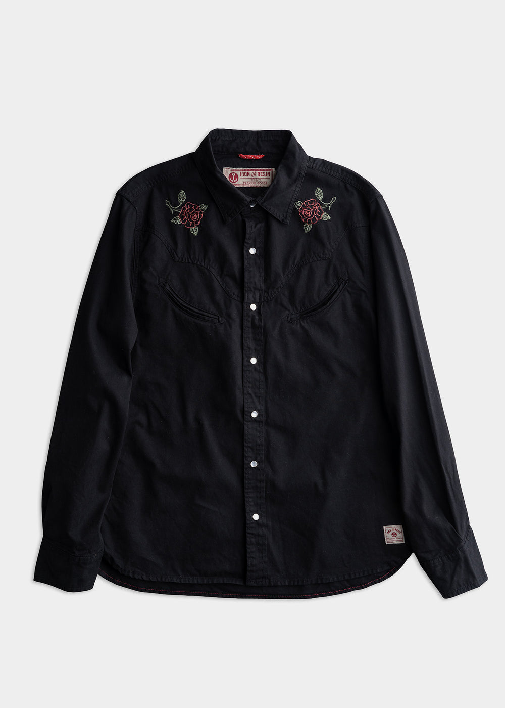 Black button-up shirt with red rose embroidery on shoulders, featuring a western style and a branded label on the bottom hem.