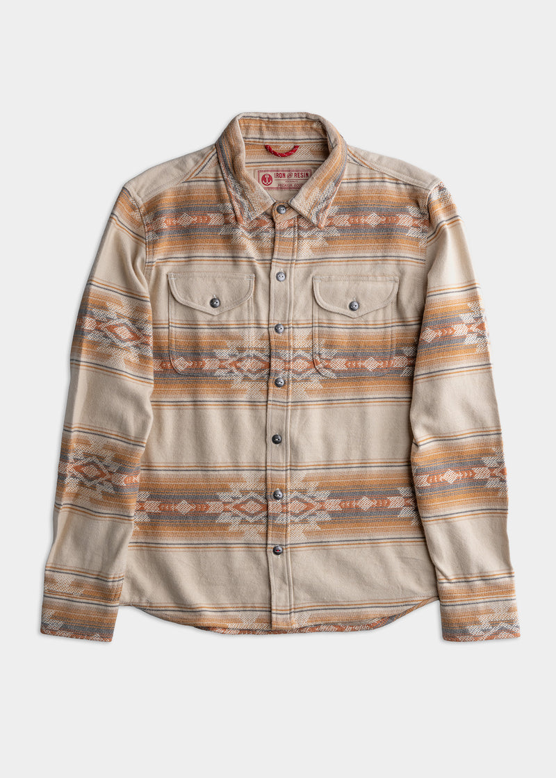 Tan and orange patterned button-up shirt with two chest pockets, featuring a southwestern design on a white background.