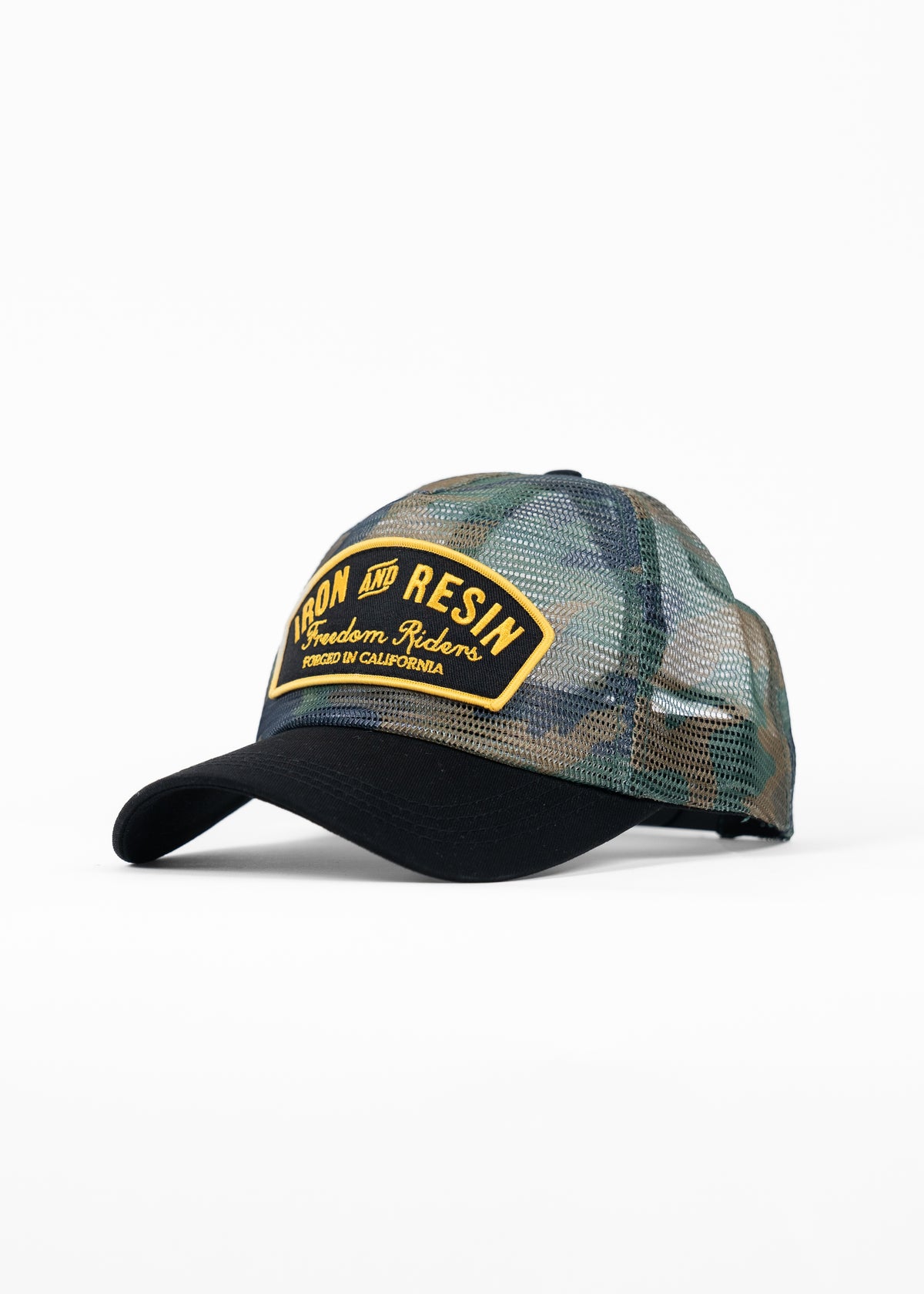Camouflage mesh trucker hat with "Iron and Resin" patch in yellow. Black brim, casual style. Forged in California.
