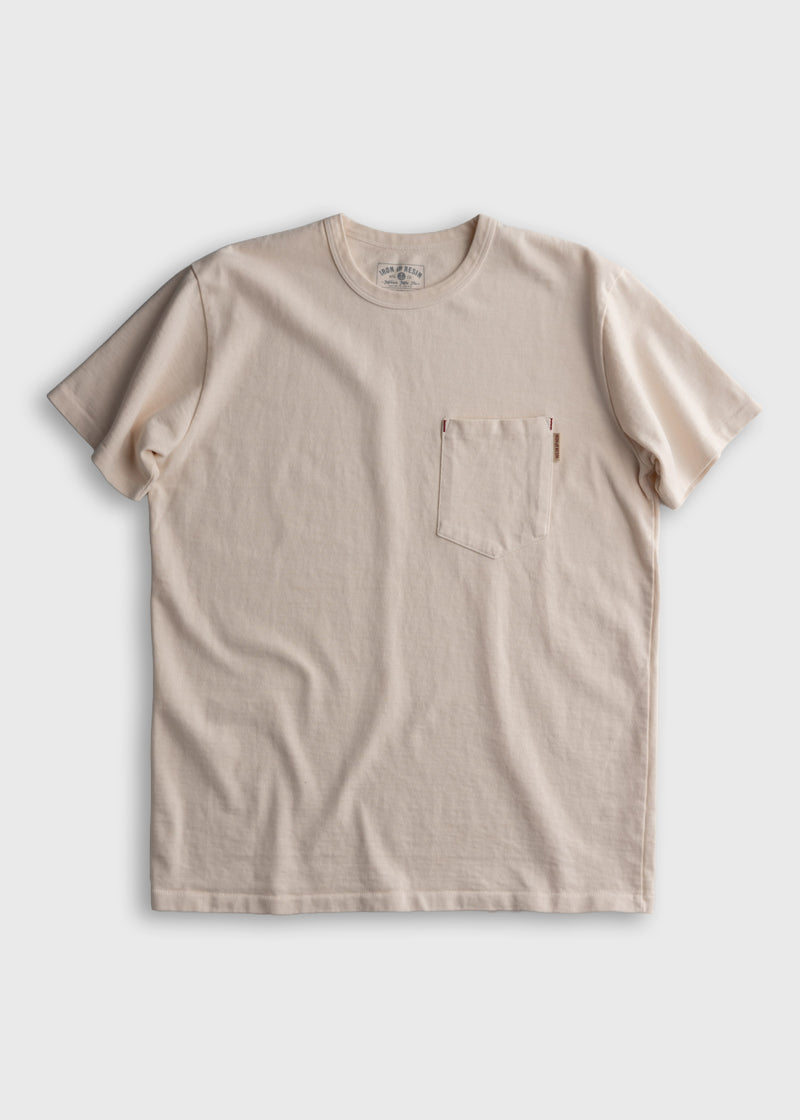 Beige crewneck T-shirt with a chest pocket, displayed on a plain background. Simple, casual design with soft fabric texture.