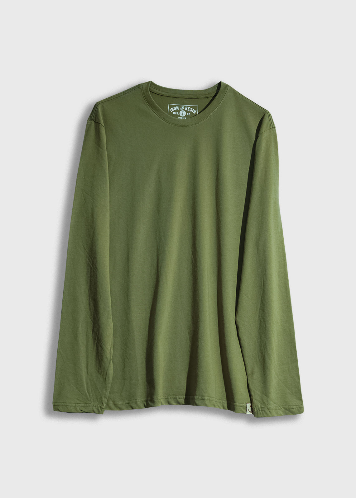 Green long-sleeve shirt with a round neckline, displayed on a white background. The label reads "Iron and Resin."
