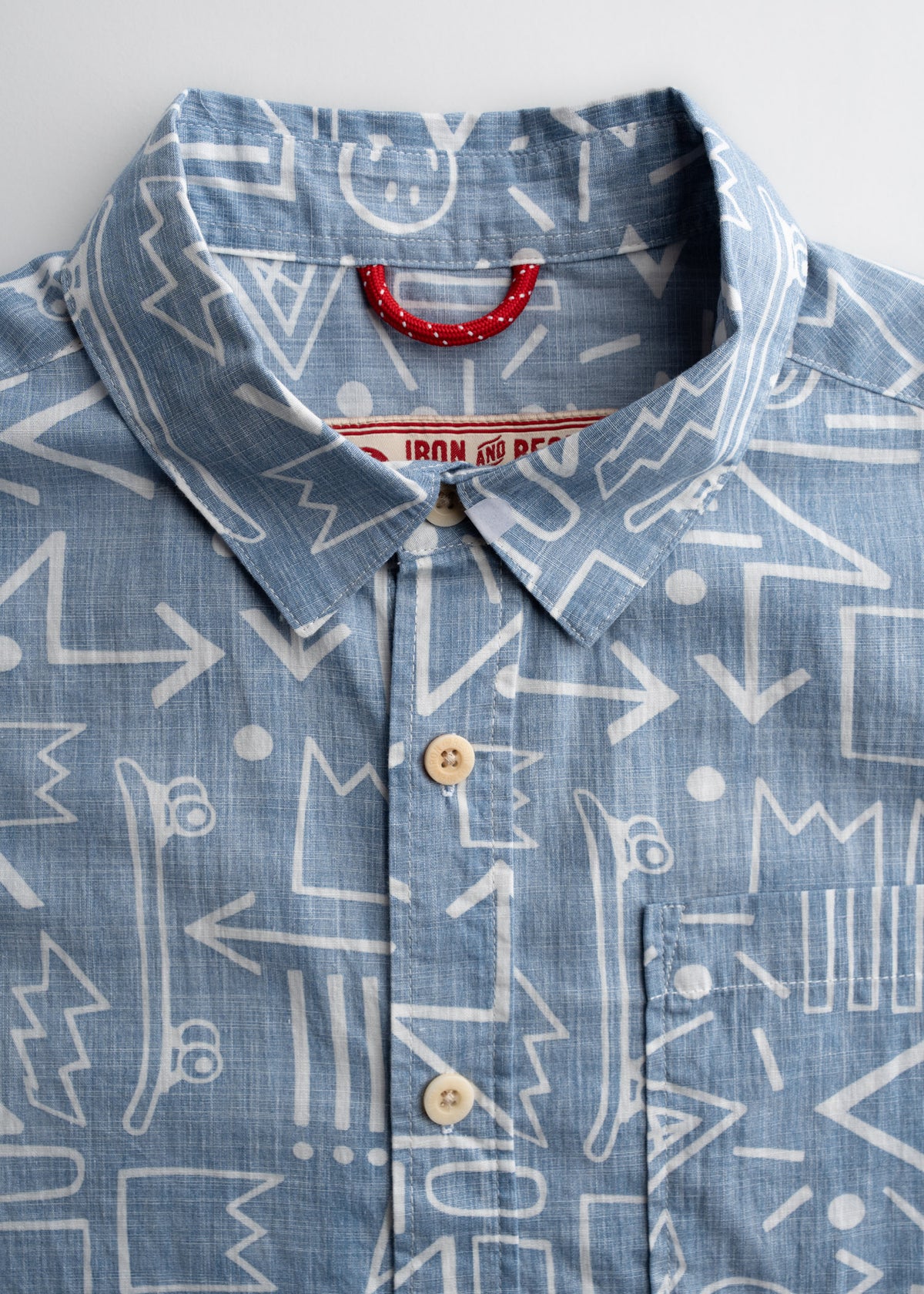 Close up of collar, buttons and label on poplin shirt, highlighting clean construction