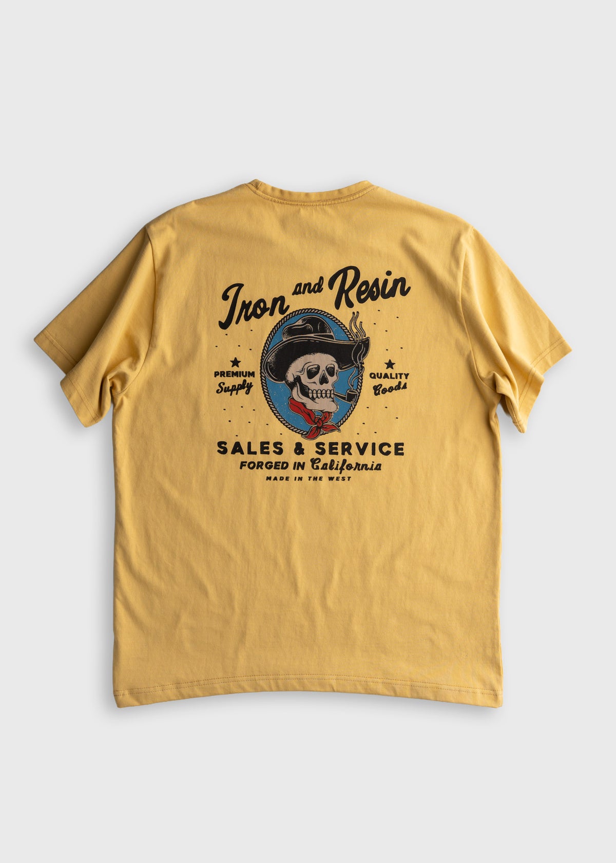 Yellow T-shirt with "Iron and Resin" logo featuring a skull in a hat, promoting premium supply and quality goods from California.