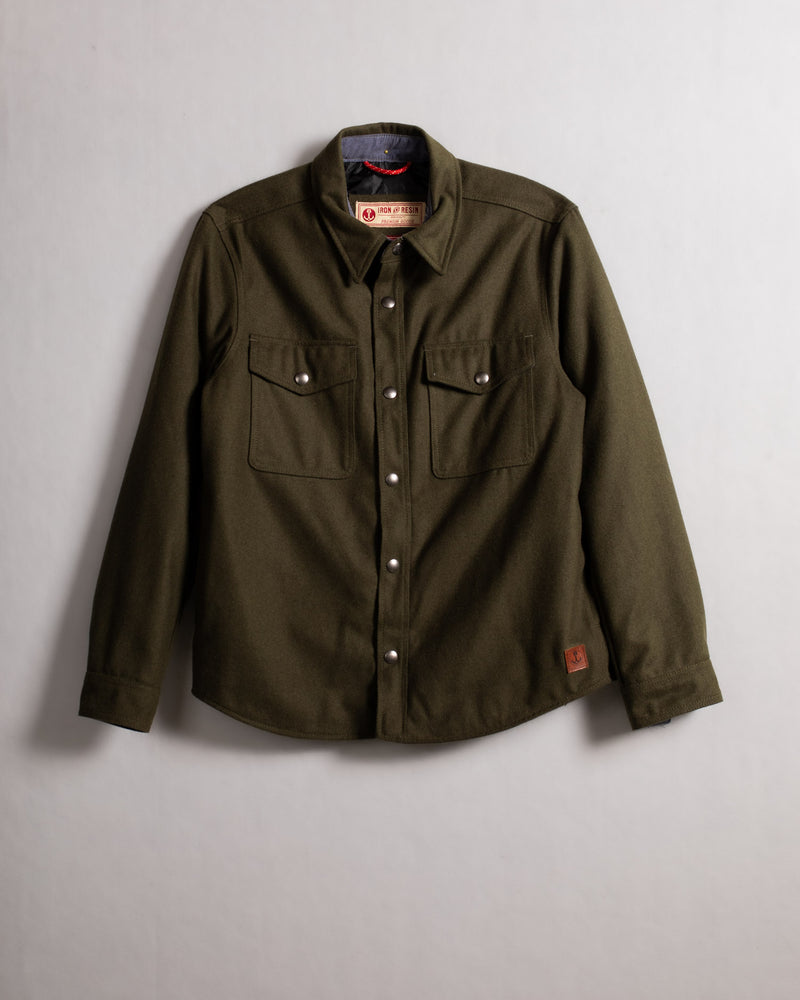 Olive green button-up shirt with two chest pockets, displayed against a plain background, showcasing its rugged, classic design.