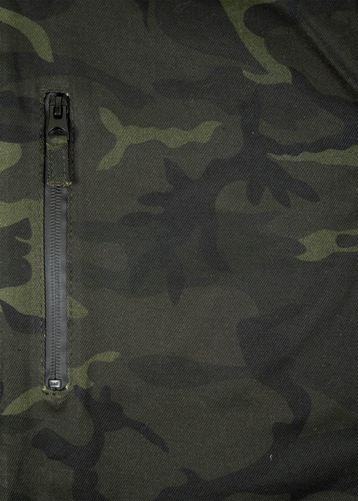 Camouflage fabric with a vertical zipper blends dark green and black shades, creating a rugged, military-inspired pattern.