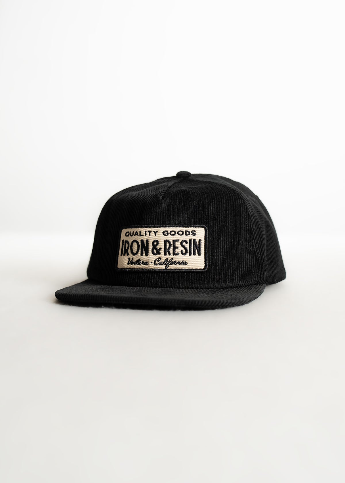 Black corduroy cap with "Iron & Resin" patch, reading "Quality Goods, Ventura, California," on a white background.