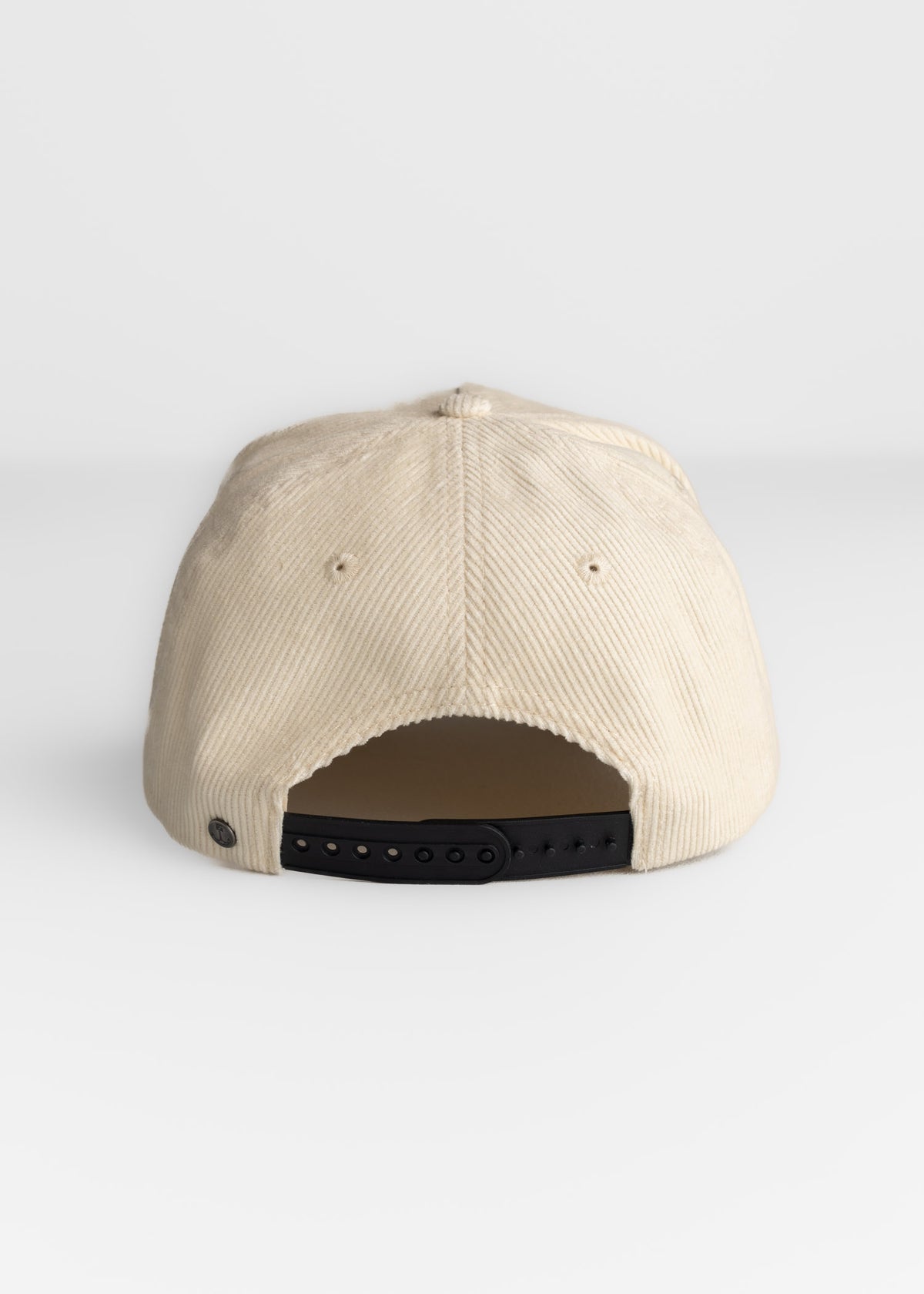 Close up of adjustable strap on corduroy hat, showcasing fit adjustment and rear closure detail