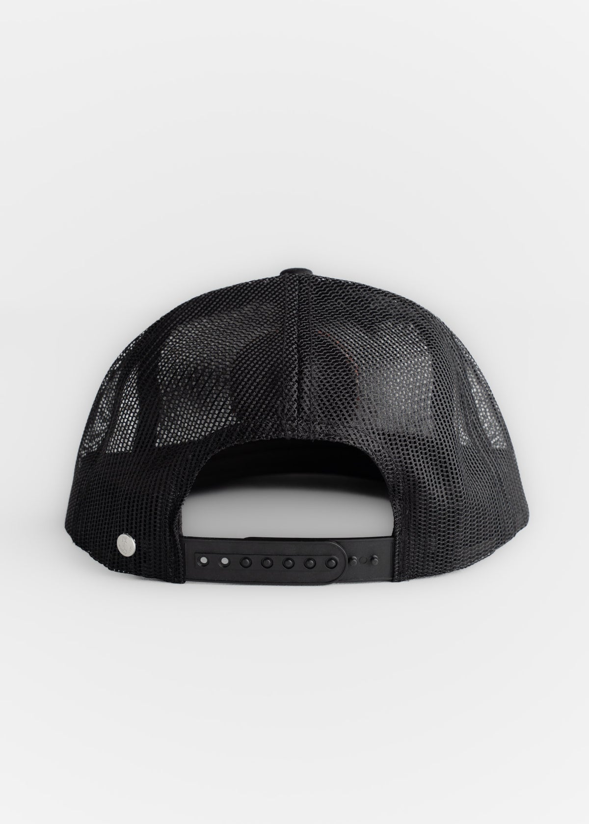 Black mesh trucker hat viewed from the back, featuring an adjustable snap closure and a breathable design on a white background.