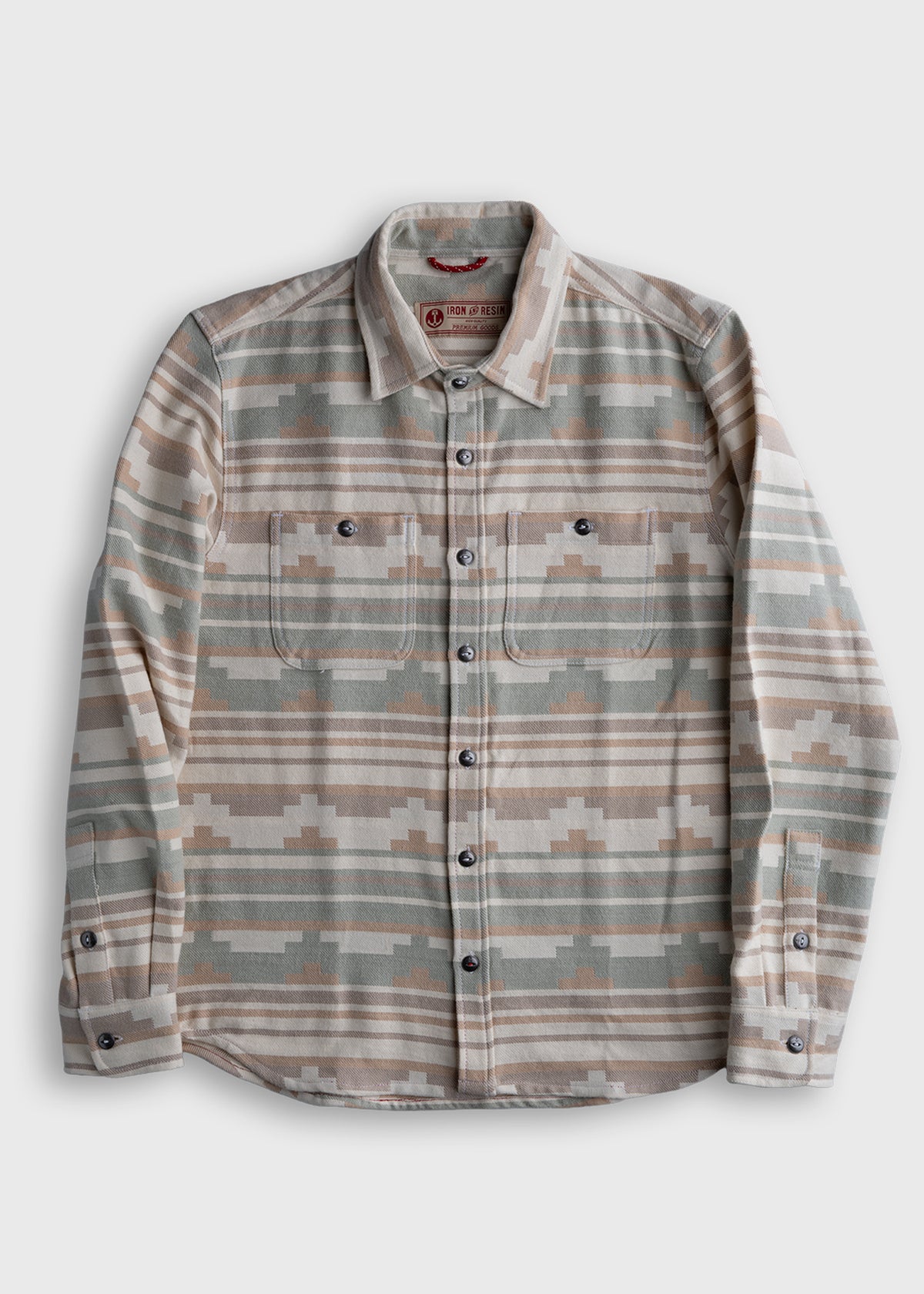 Patterned flannel shirt with earthy tones, buttoned front, and two chest pockets, laid flat on a white background.