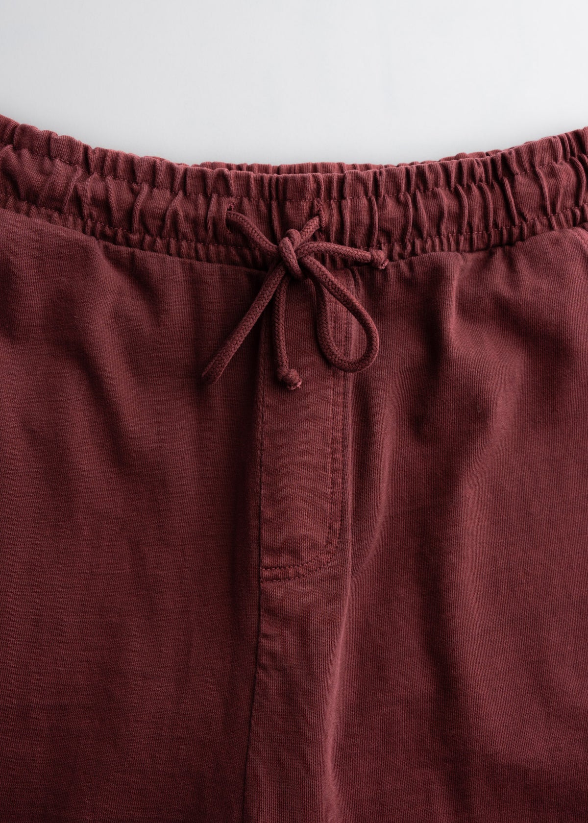 Close up of elastic waistband and drawstring on sweatpants, highlighting fit and comfort