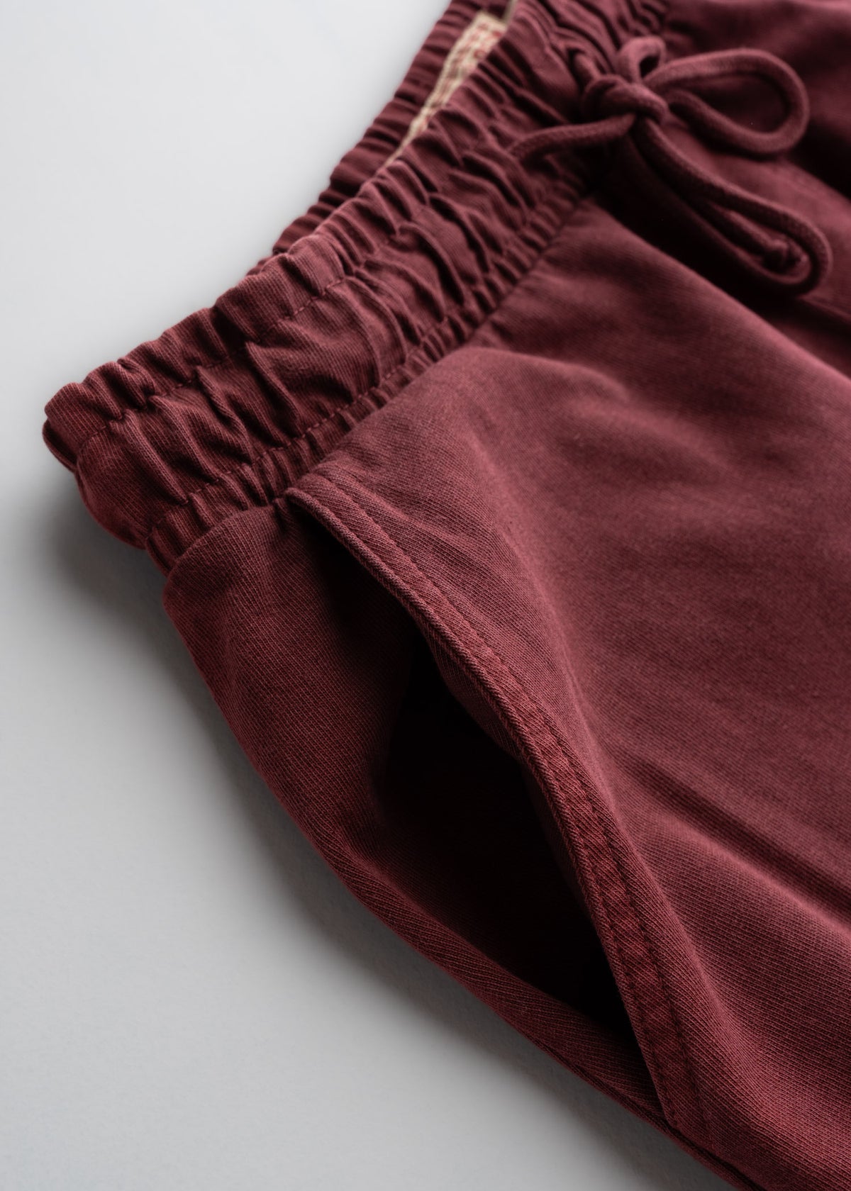 Close up of dual hand pockets on sweatpants, highlighting stitching and everyday functionality