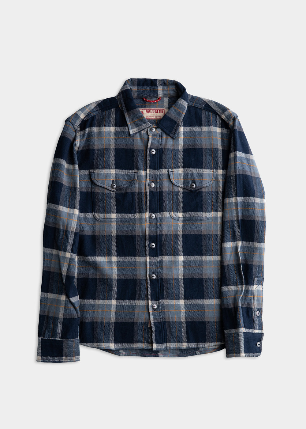 Blue and gray plaid flannel shirt with buttoned pockets and collar, laid flat on a white background.