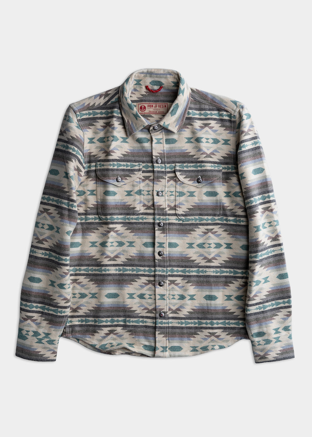Patterned button-up shirt with geometric designs in teal and gray tones, featuring two chest pockets and a classic collar.