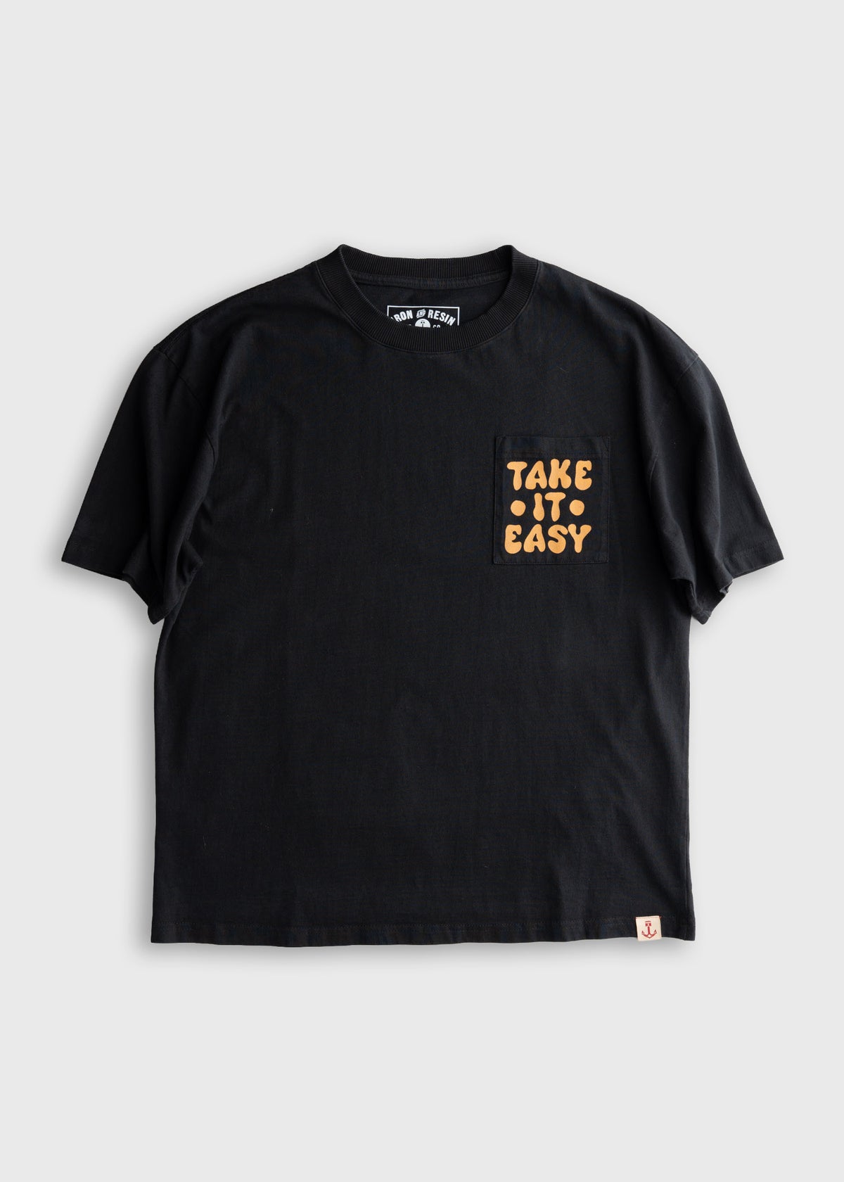 Black t-shirt with "Take It Easy" text on the pocket, featuring a small anchor logo at the bottom. Casual and relaxed style.