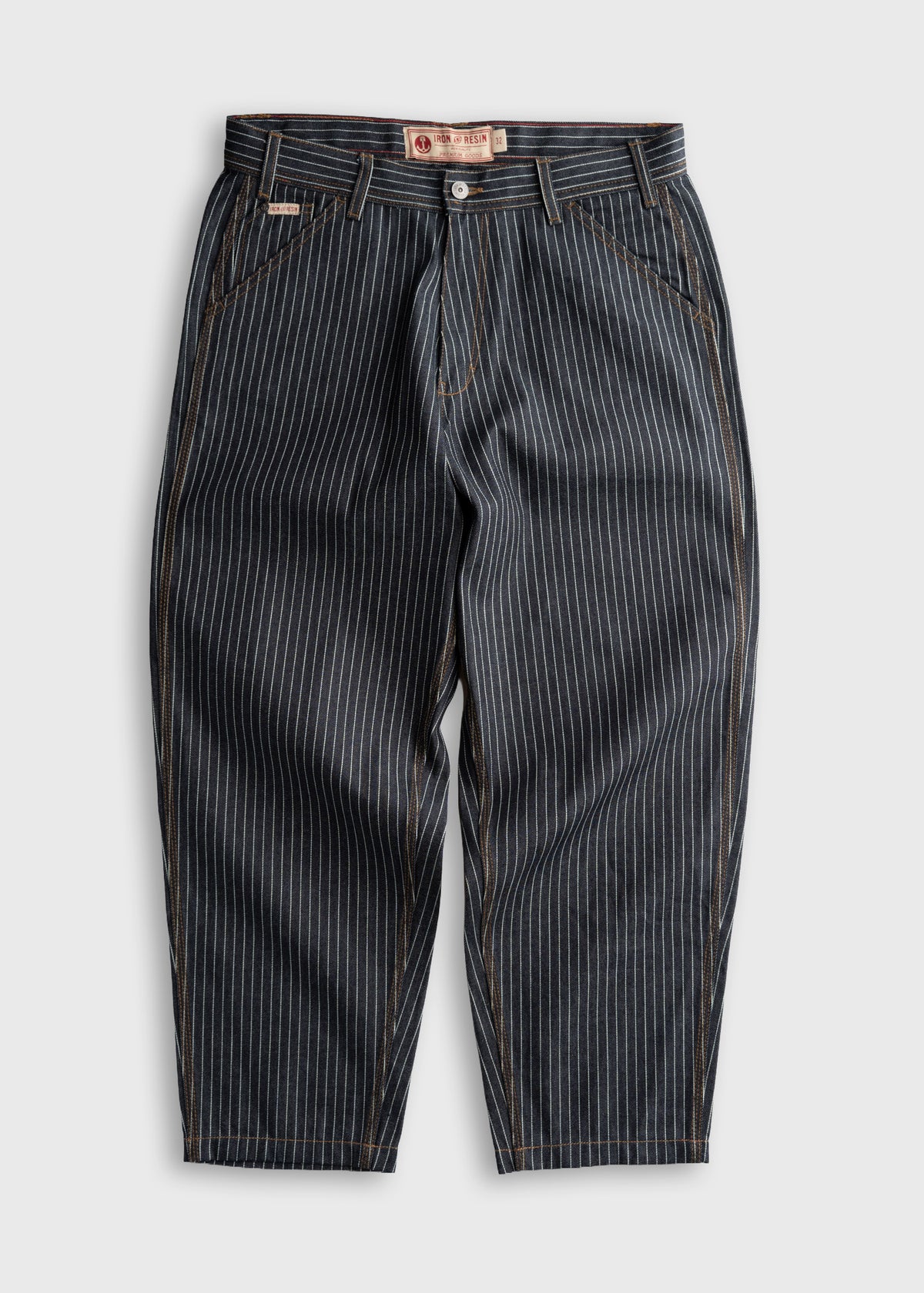 Pinstriped pants with a button closure and belt loops, displayed on a white background, showcasing classic tailoring details.