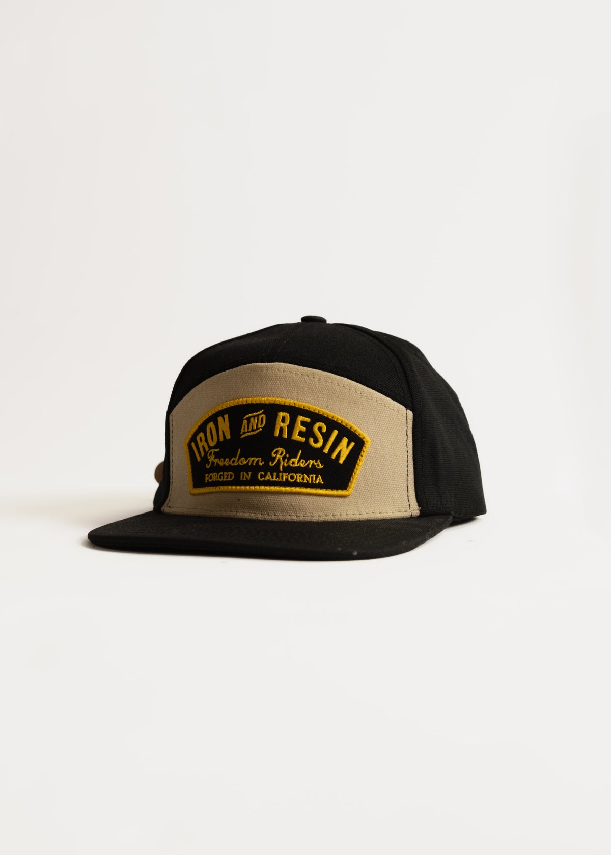 Black and tan cap with "Iron and Resin" logo, "Freedom Riders" text, and "Forged in California" on the front panel.