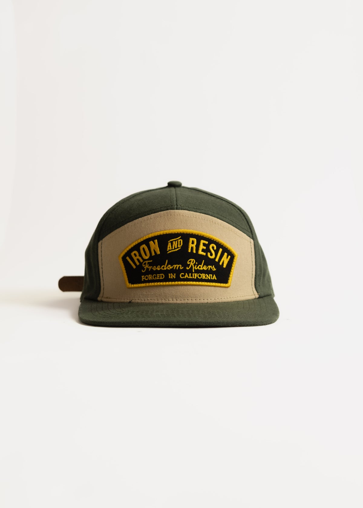 Green and beige cap with "Iron and Resin" logo, "Freedom Riders" text, and "Forged in California" on the front, isolated on white.
