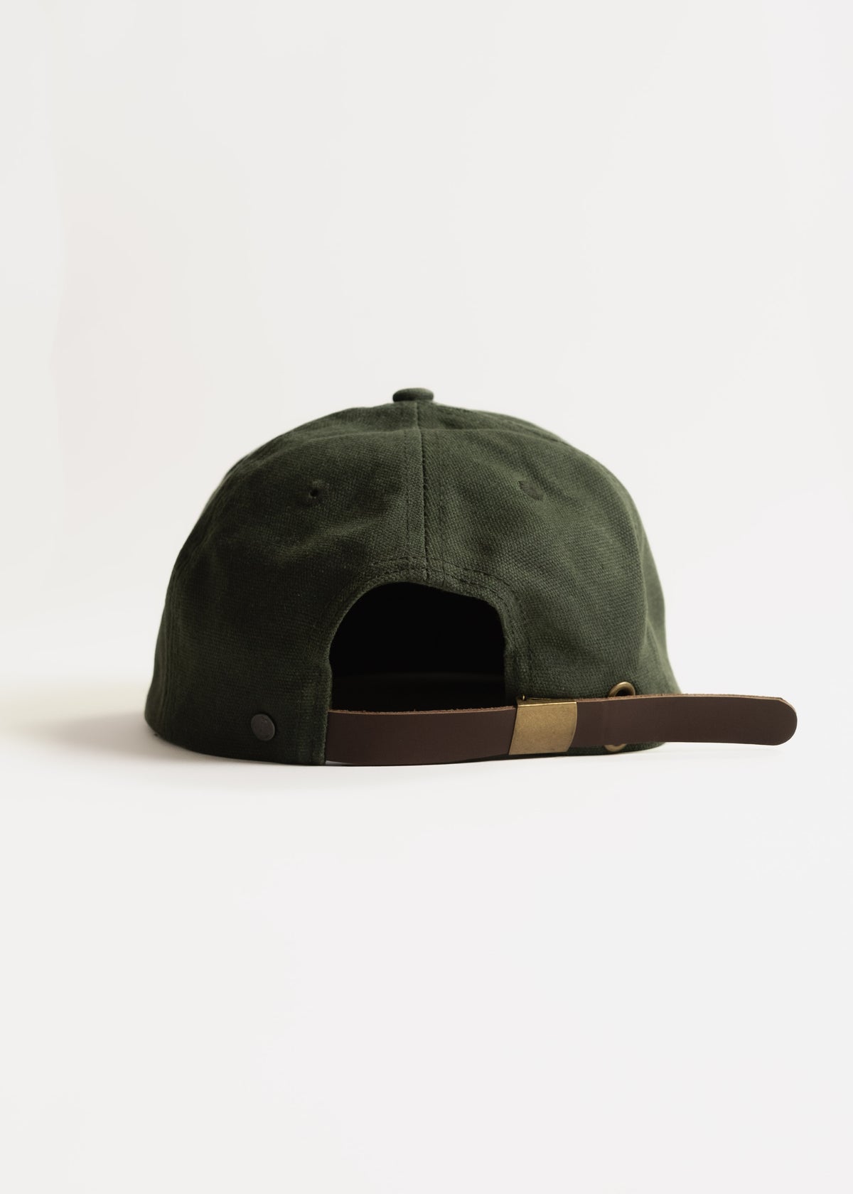 Dark green baseball cap with adjustable brown strap, viewed from the back on a white background.