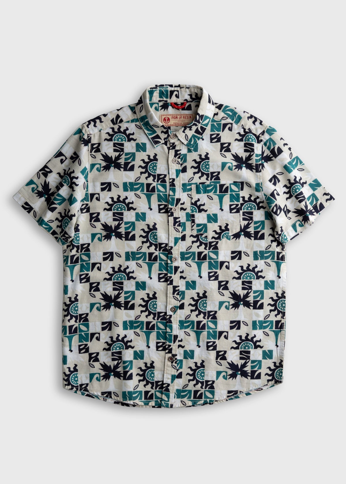 Short-sleeve shirt with geometric and sun patterns in teal and black on a white background, featuring a button-down front.