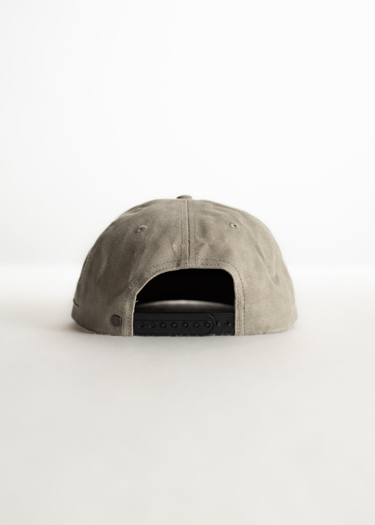 Back view of a gray baseball cap with an adjustable black strap, set against a plain white background.