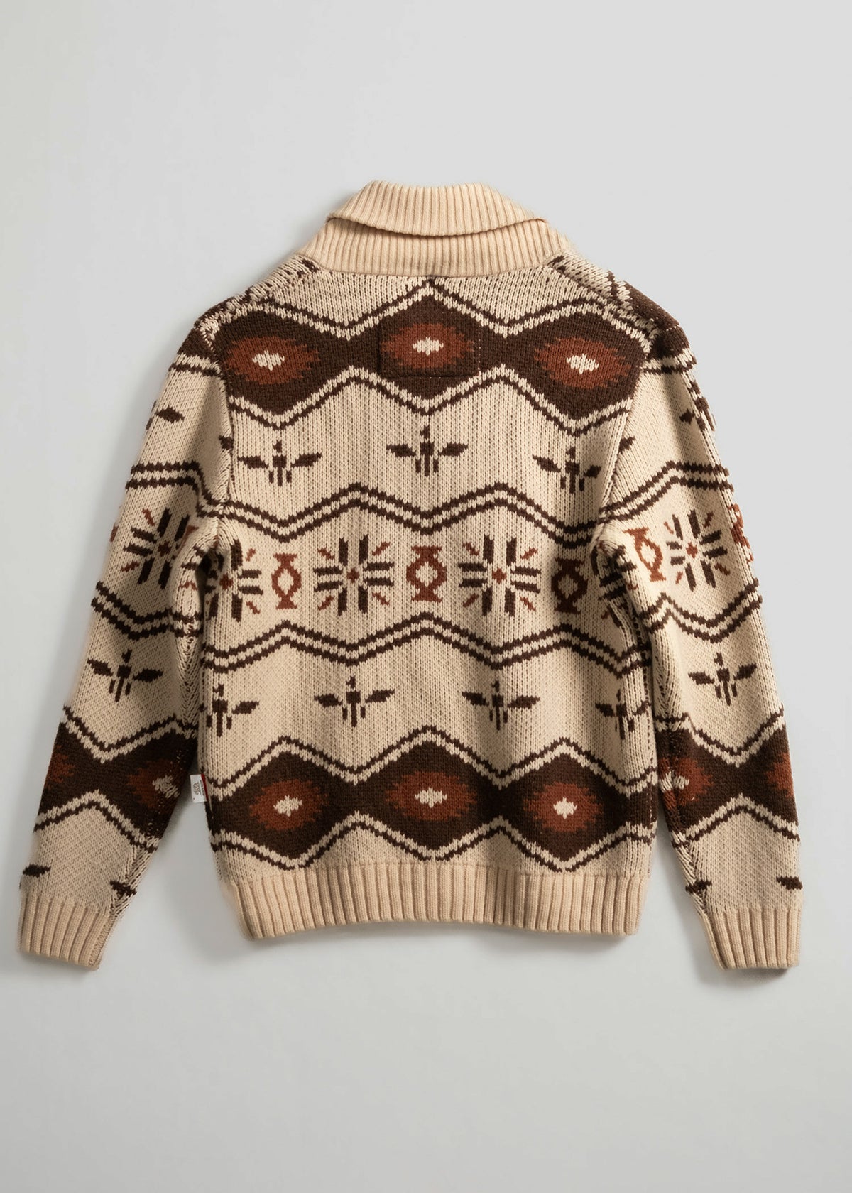 Beige sweater with brown geometric patterns and ribbed collar, laid flat on a light background, showcasing intricate design.