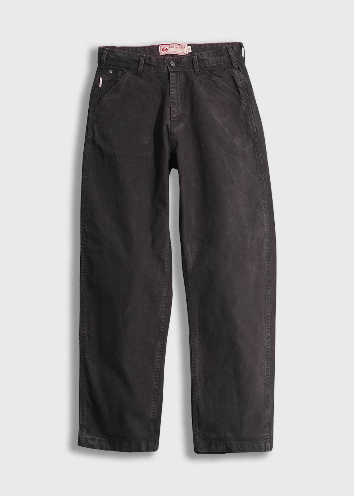 Black denim pants with a relaxed fit, featuring front pockets and belt loops, displayed on a white background.